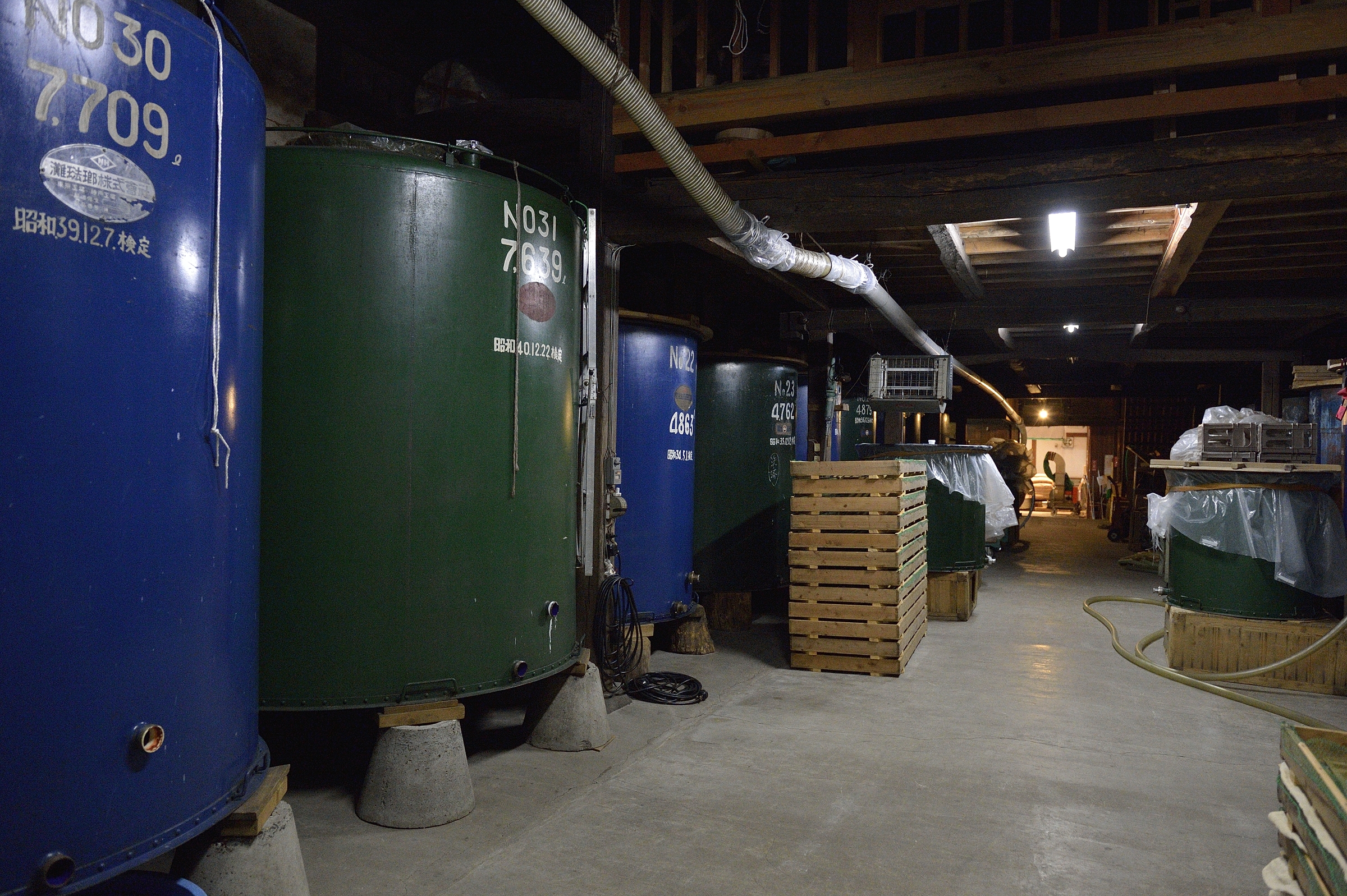 Rows of old fermentation/storage tanks inside the brewery