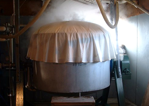 Steaming rice in a large koshiki vat, part of the brewing process page