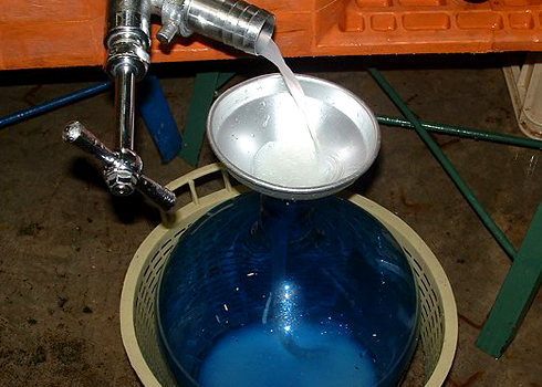 Freshly pressed sake being filtered into a container