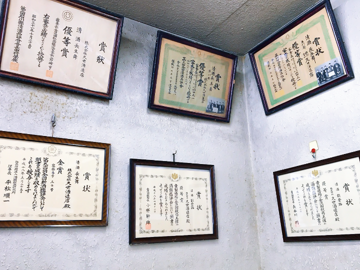 Wall display of the brewery's award certificates from national sake competitions.