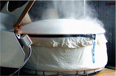 Steam rising from rice steaming vessel