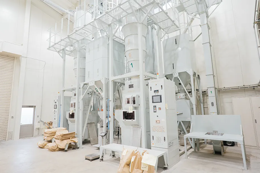 Interior of the dedicated sake-rice polishing facility with rice-milling equipment.