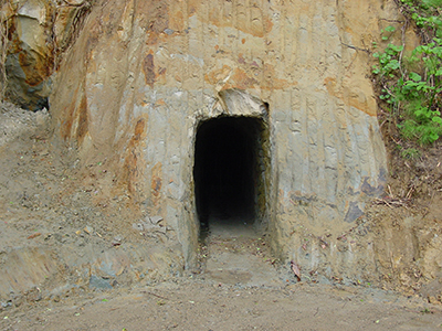 Entrance to the natural cave used for cold storage and aging of sake