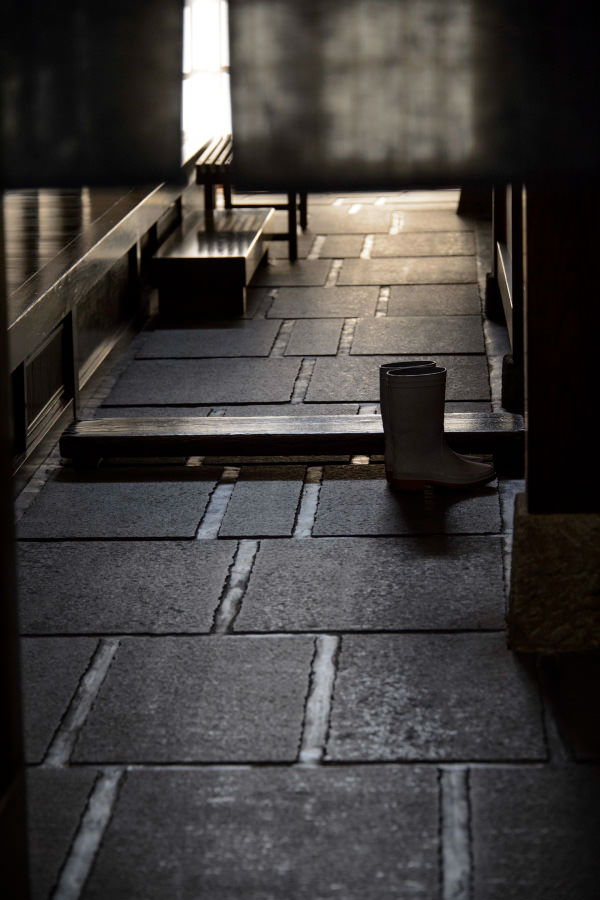 Interior entrance corridor of the brewery, with a worker's rubber boot by the doorway