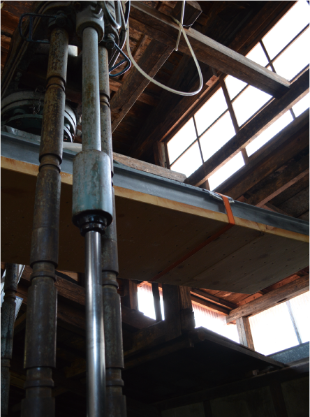 Interior of the brewery building with wooden press equipment