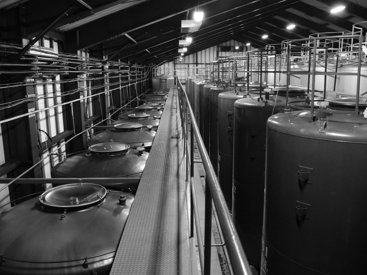 Rows of refrigerated storage tanks inside the brewery.