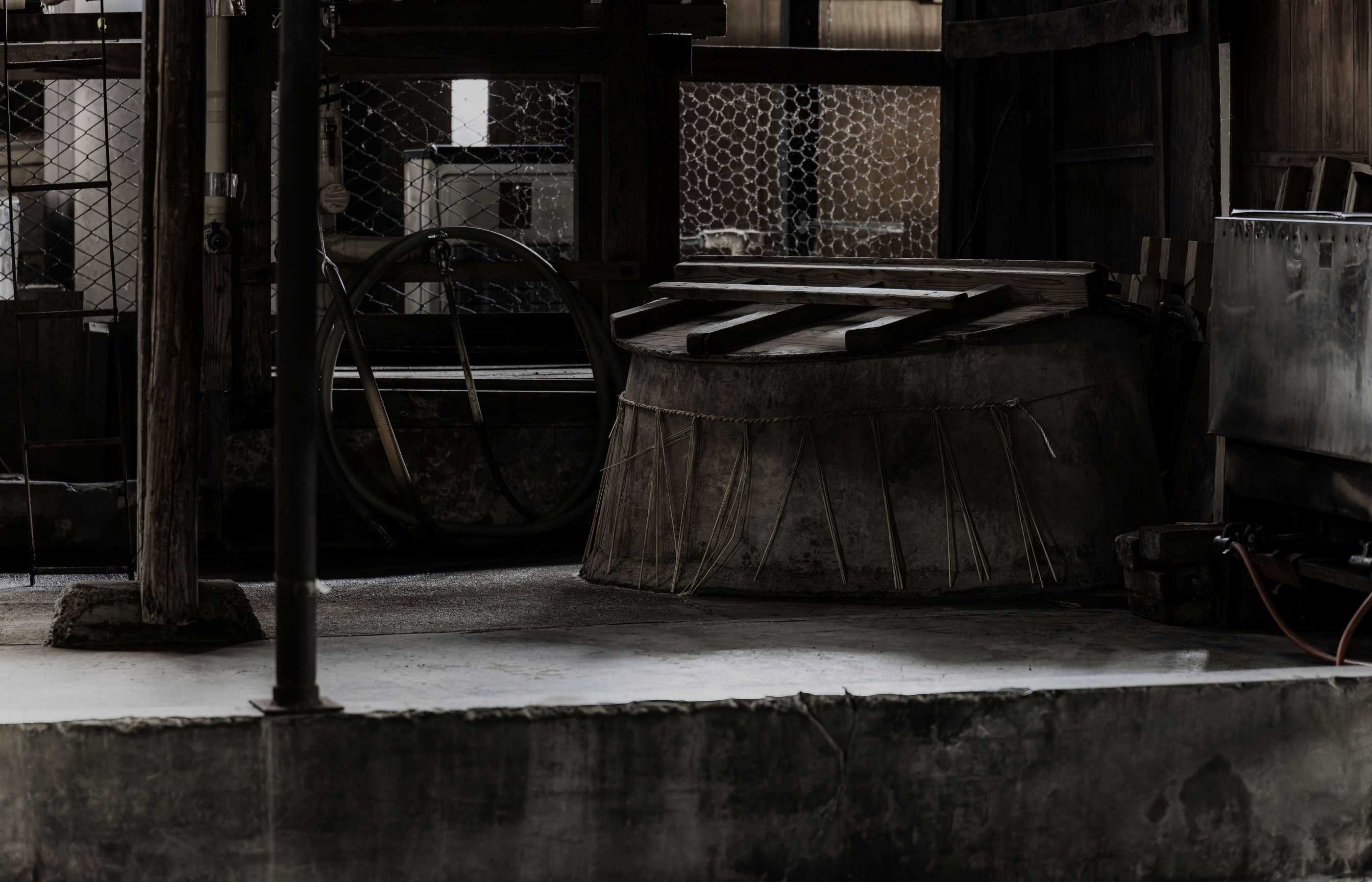 A traditional wooden fermentation vessel (koshiki) inside the brewery.