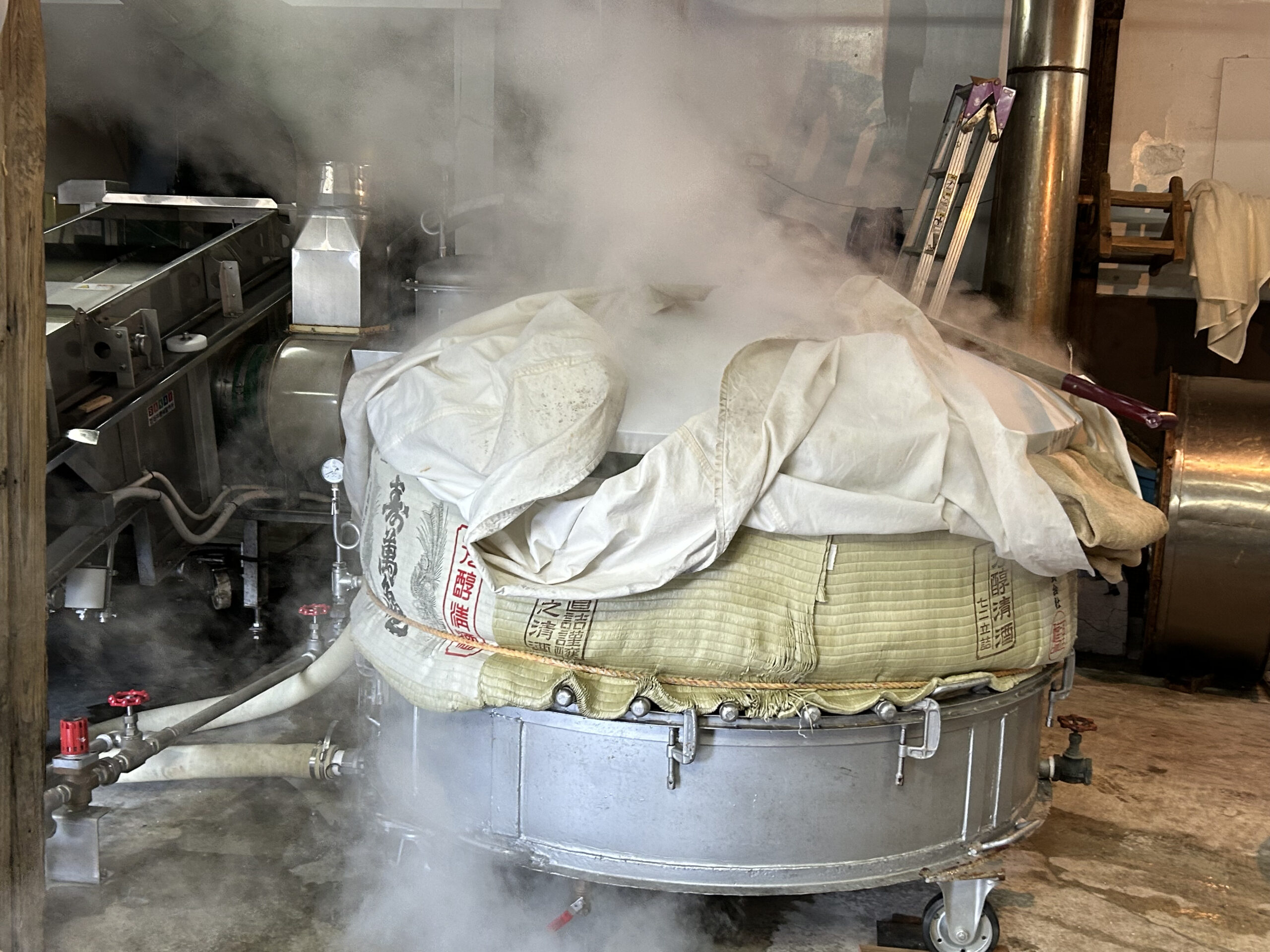 Steam rising from the moromi (mash) during pressing
