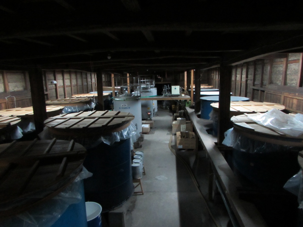 Interior of the roughly 100-year-old brewing hall with fermentation tanks, shown during tour introductions.