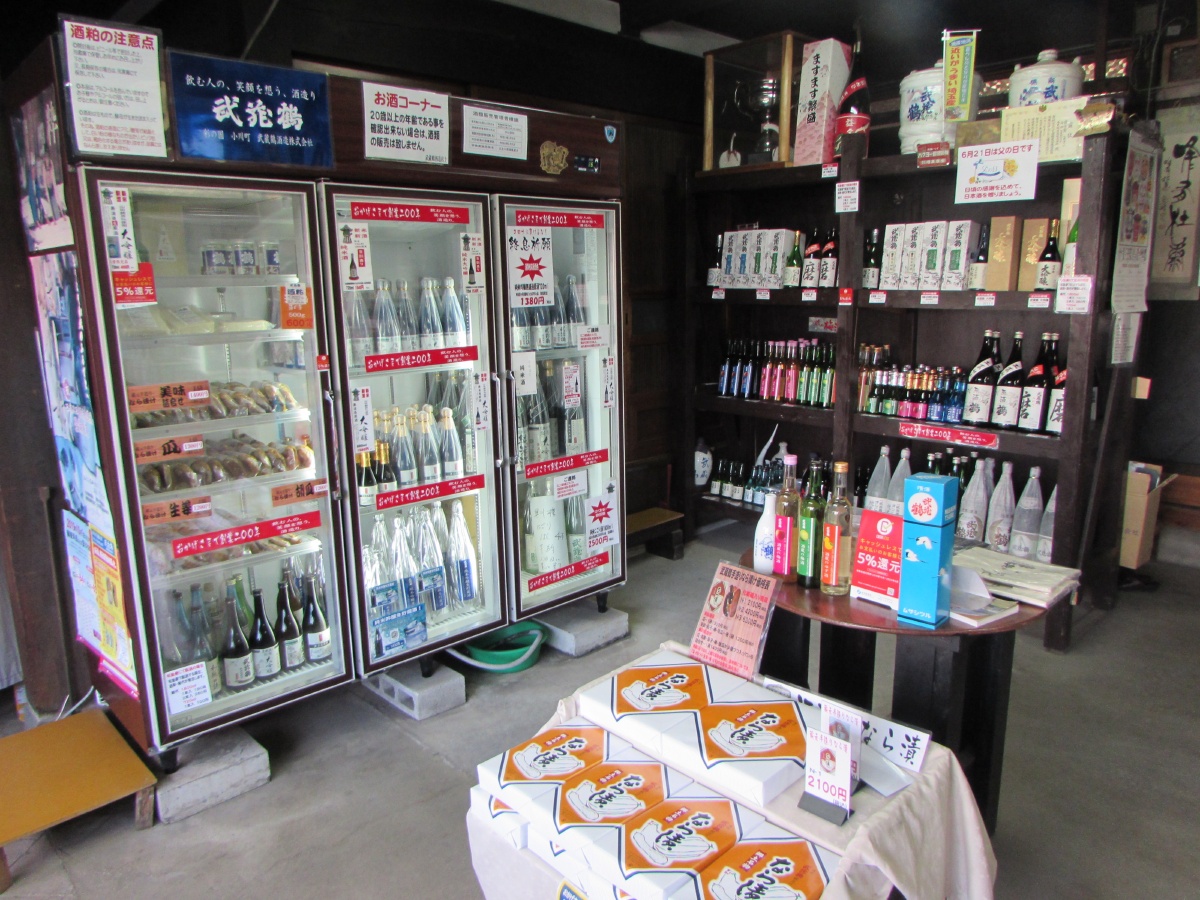 Interior of the brewery's direct sales shop stocked with Musashitsuru sake bottles.