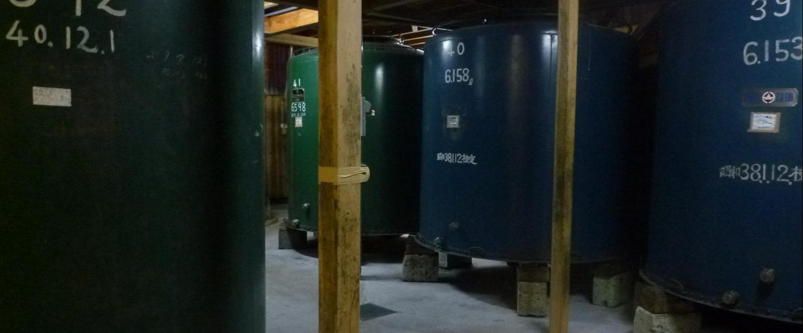 Rows of large storage tanks inside the brewery.