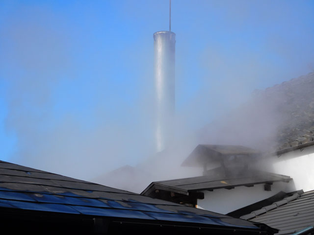 The brewery chimney venting steam during sake production
