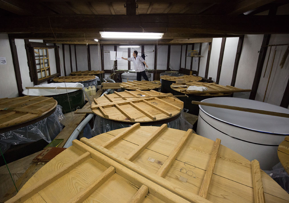 Interior of the fermentation room lined with covered brewing tanks.