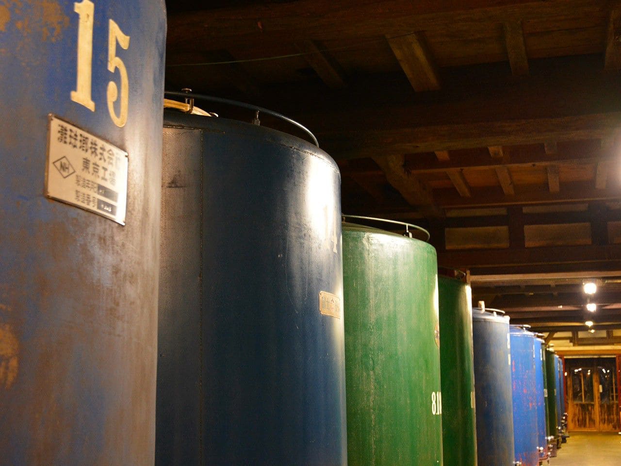 Row of brewing storage tanks inside the brewery