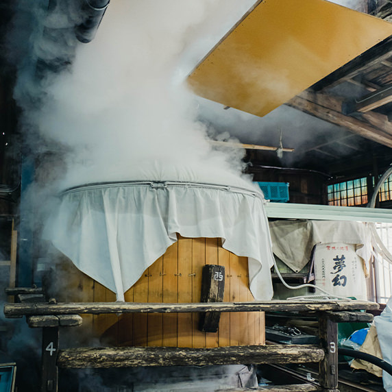 Steam rising from the koshiki steamer used to steam the rice.