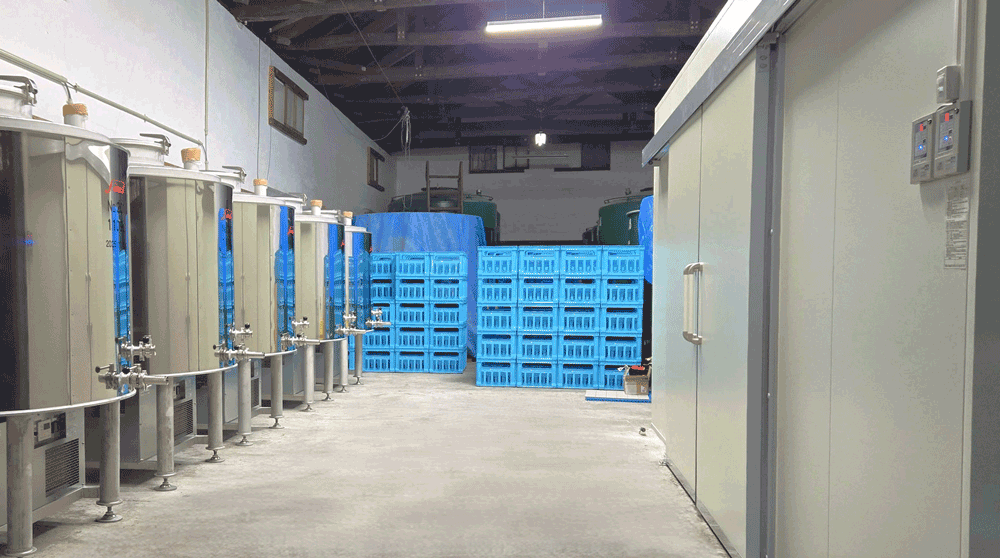 Interior storage area with fermentation tanks and crates
