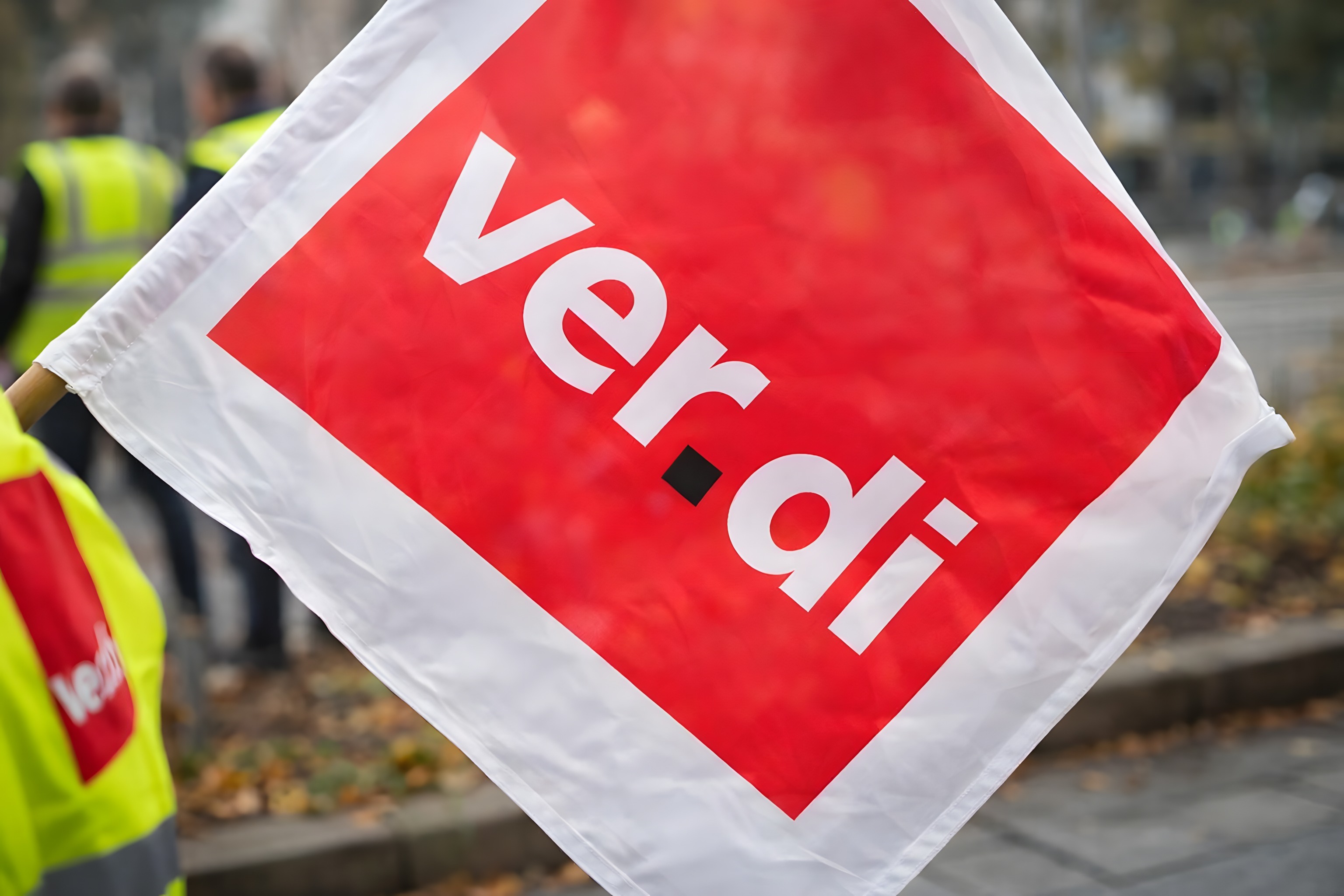 ver.di flag at demonstration & strike with safety vests in the background