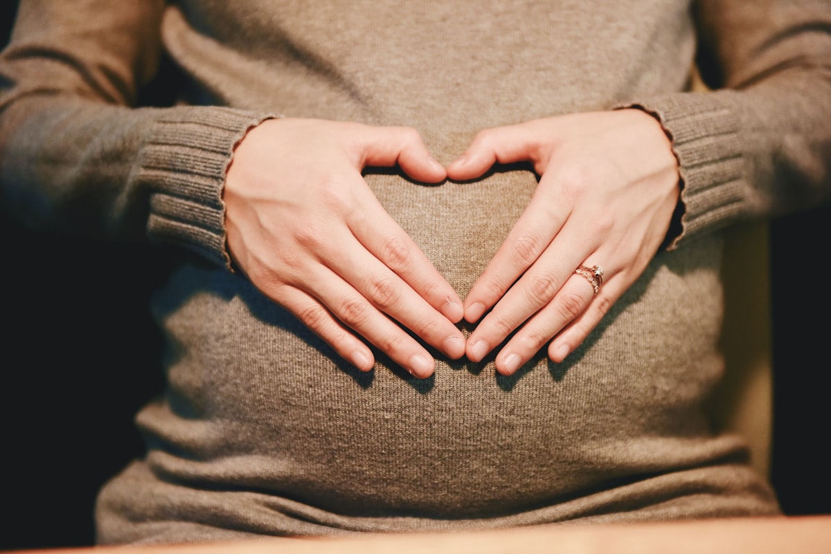 Leafy greens and citrus arranged for an early pregnancy nutrition read