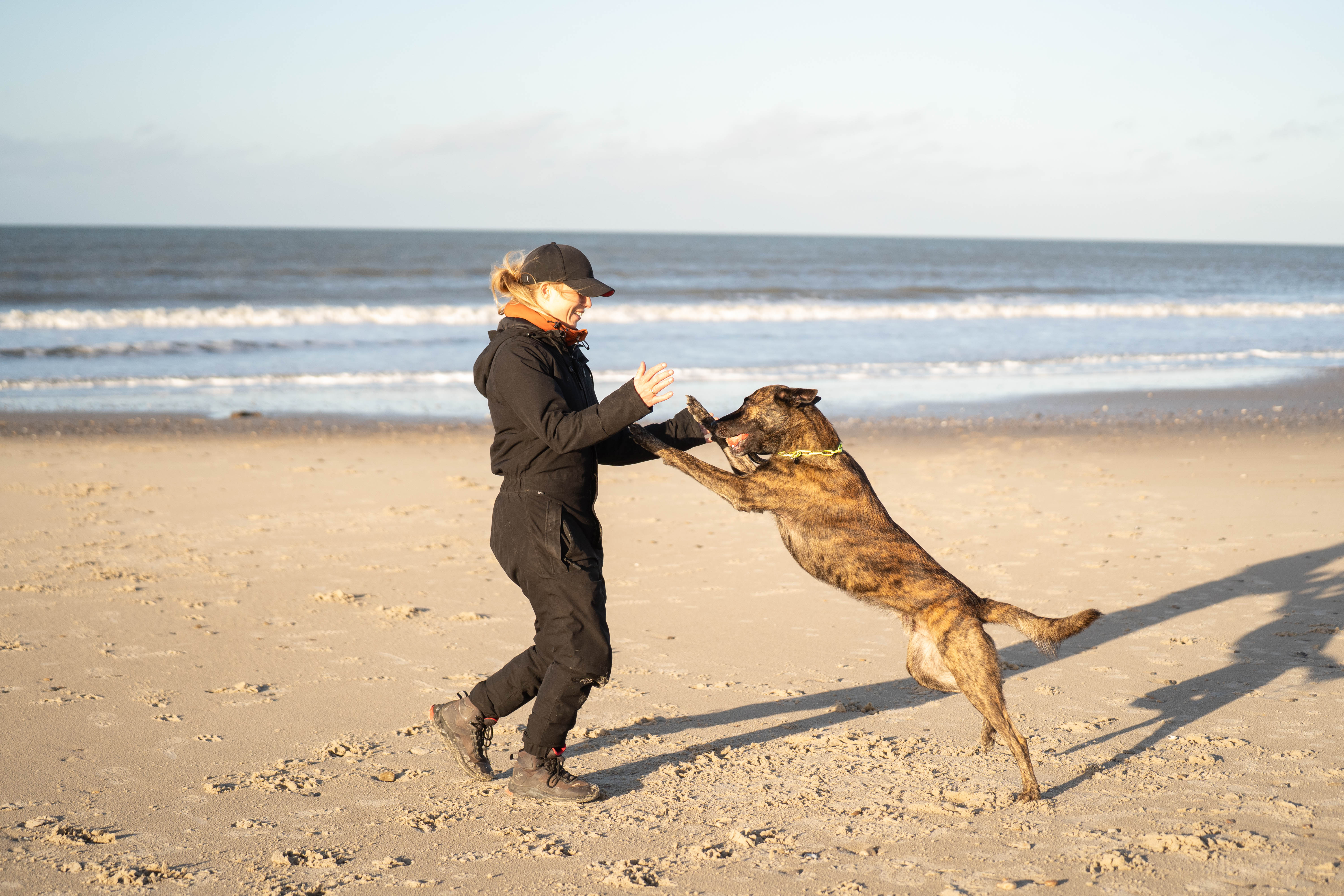 a group of people sitting outside looking at a laptop a group of people sitting outside looking at a laptop