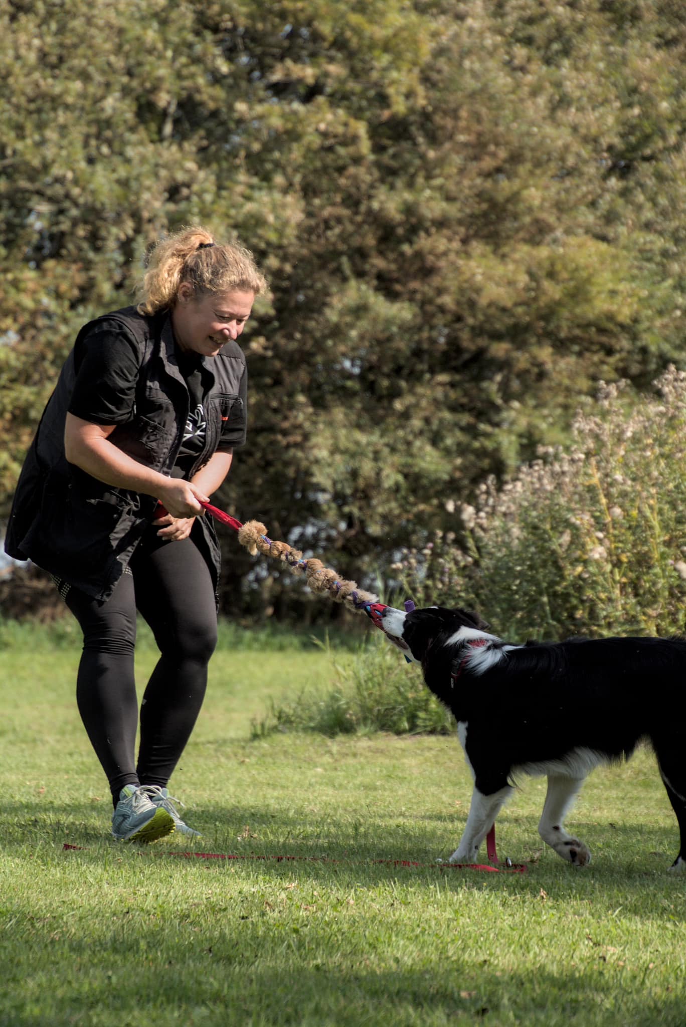 a group of people sitting outside looking at a laptop a group of people sitting outside looking at a laptop
