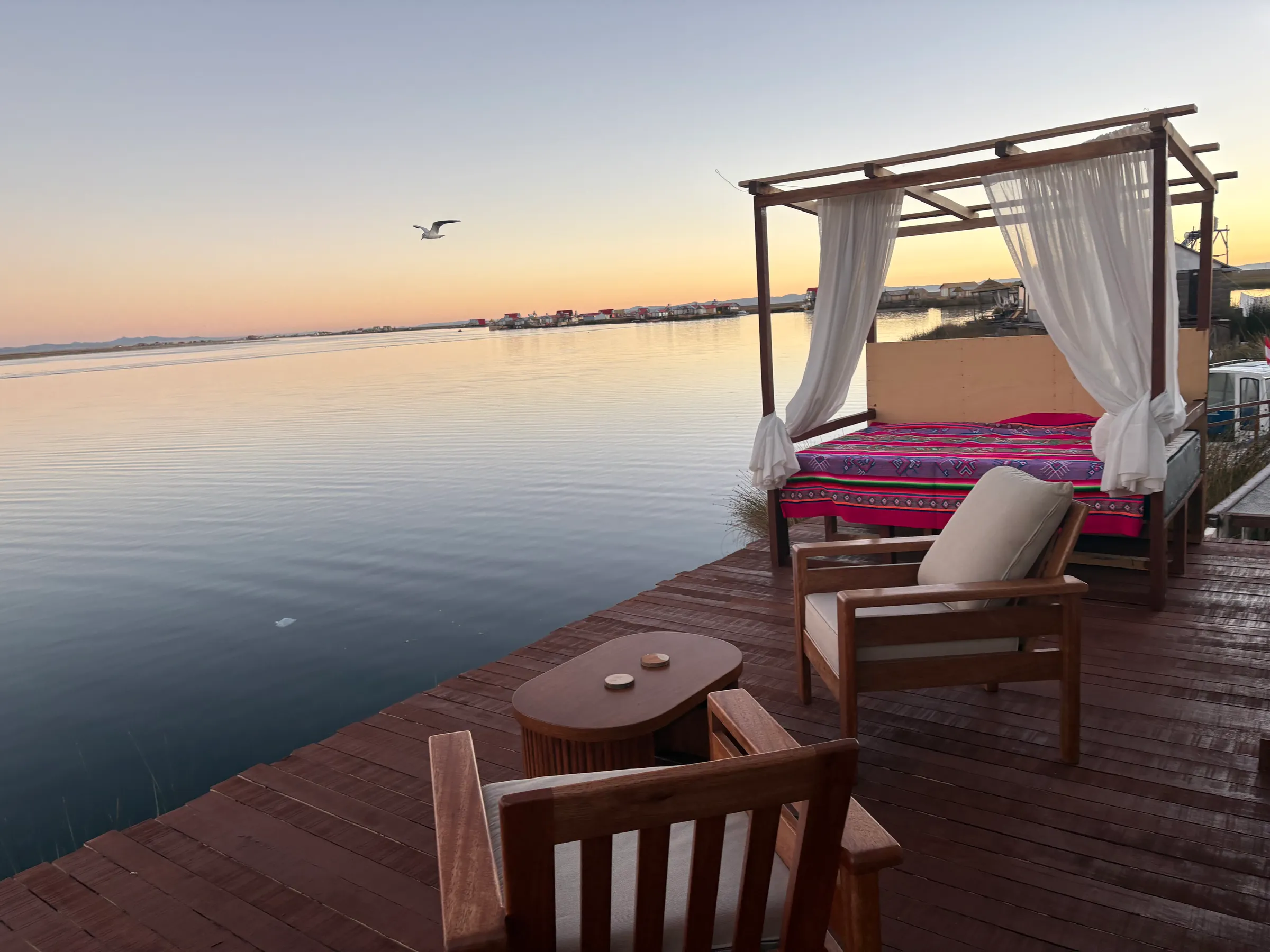 Canopy daybed on the deck at sunset over Lake Titicaca