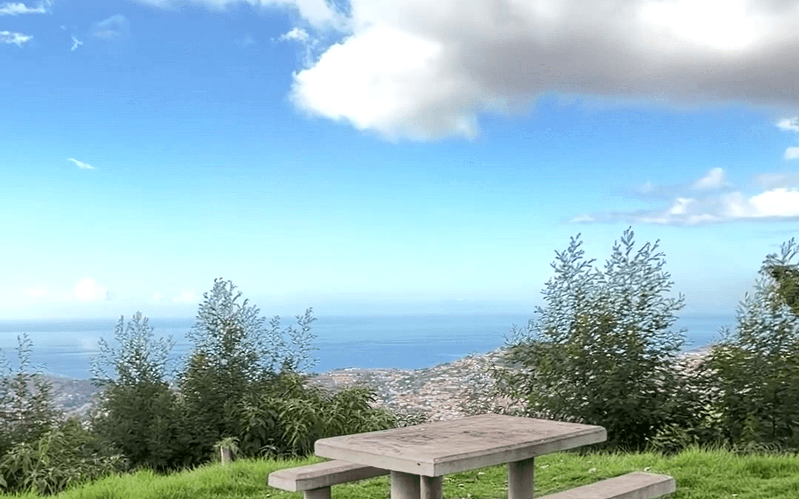 Picnic table with a panoramic view over Funchal and the Atlantic from Parque de Merendas do Galeão