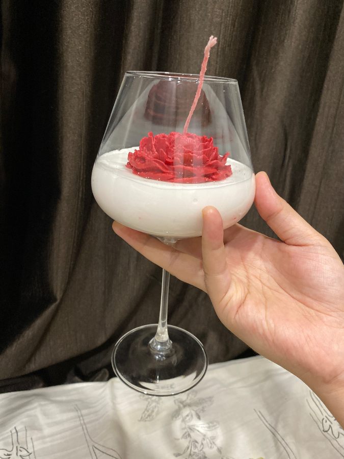 Rose candle in wine glass