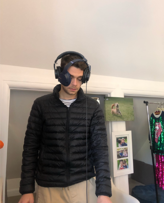 Luca wearing two sets of headphones