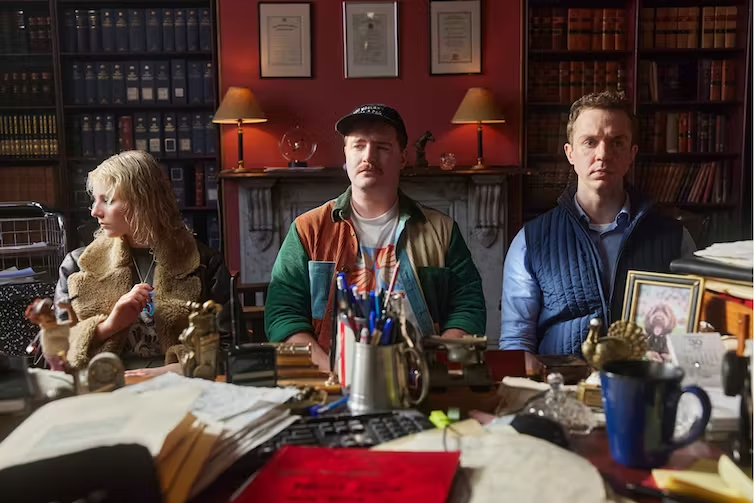 Thomasin McKenzie, Brandon McClelland and Rowan Witt sitting in a lawyer's office