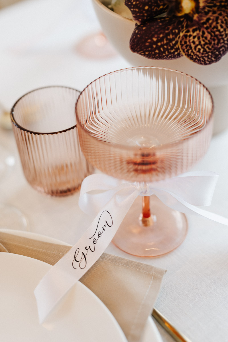 Rosa Glas mit geriffelter Oberfläche und weissem Band mit Aufschrift Groom