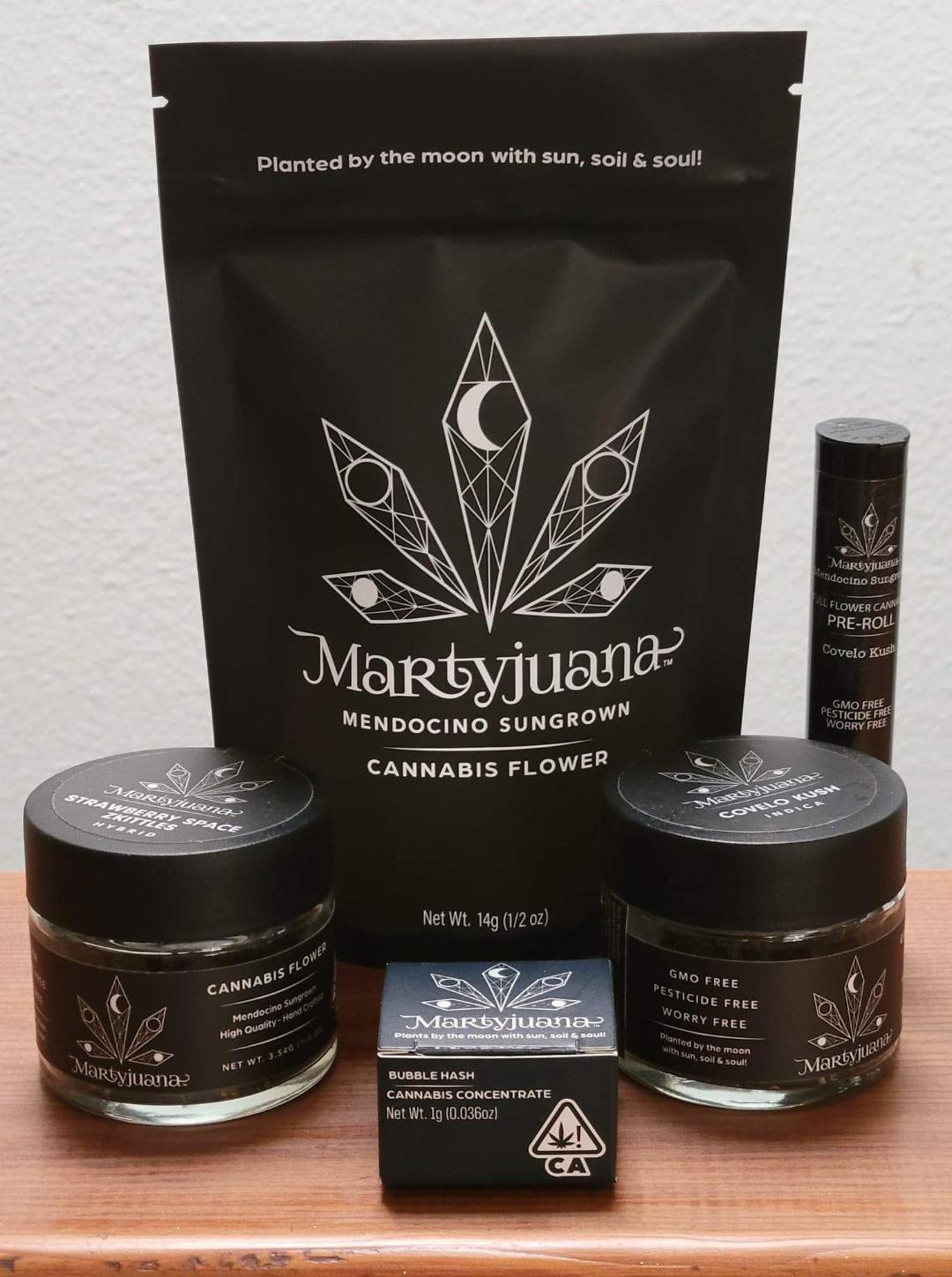 Martyjuana branded pouches and glass jars arranged together