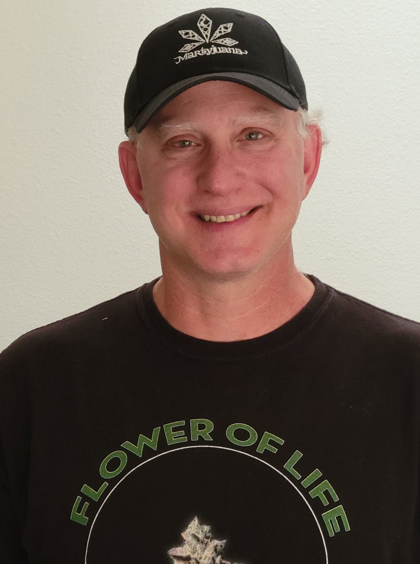 Portrait of a person wearing a Martyjuana cap and Flower of Life shirt