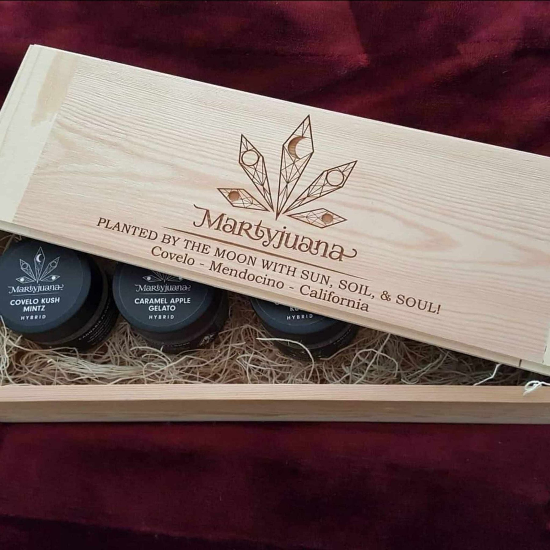 An open Martyjuana presentation box containing labeled jars