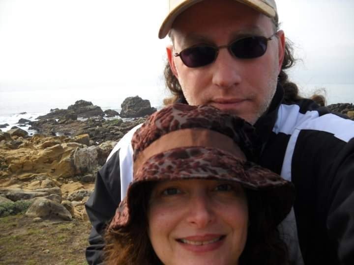 Marty and Laura taking a selfie beside rocks on the Mendocino coast