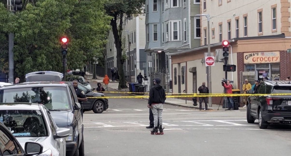 Woman shot in back as gunfire erupts on busy Roxbury street