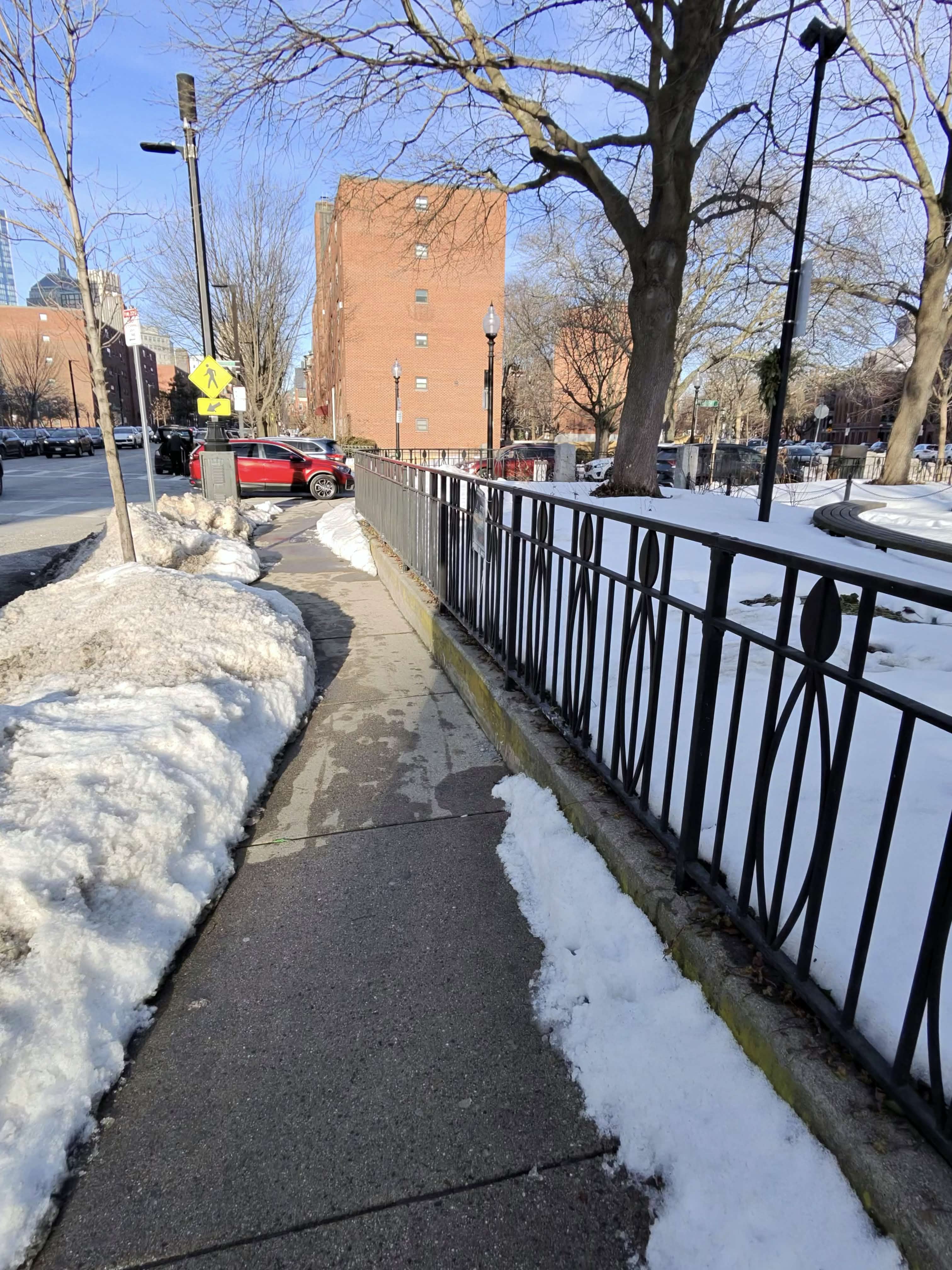 Narrow Boston sidewalk squeezed between snow banks