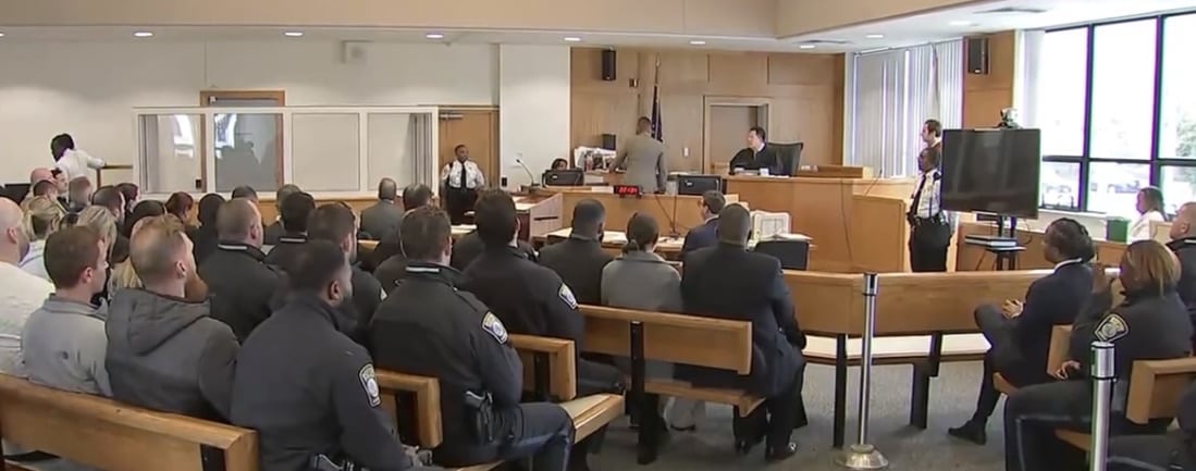 Boston police officers fill the courtroom at Roxbury District Court