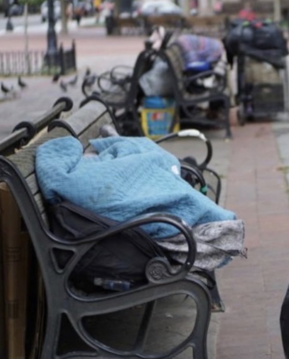 Belongings piled on public benches near Copley Square