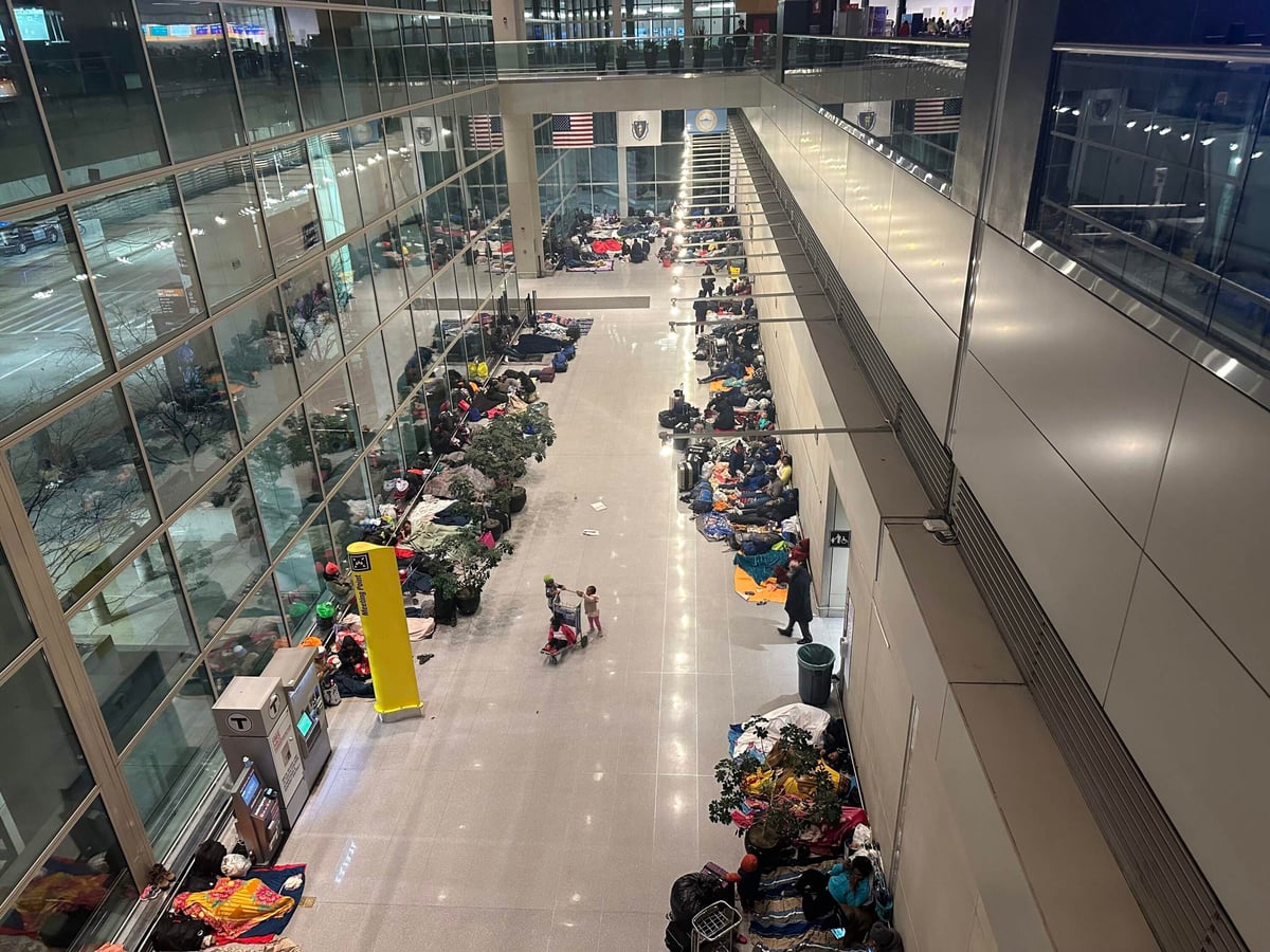 Migrant families sleeping at Boston's Logan International Airport