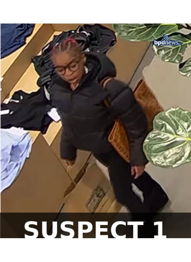 Suspect 1 — blue hat, black sweatshirt, black pants