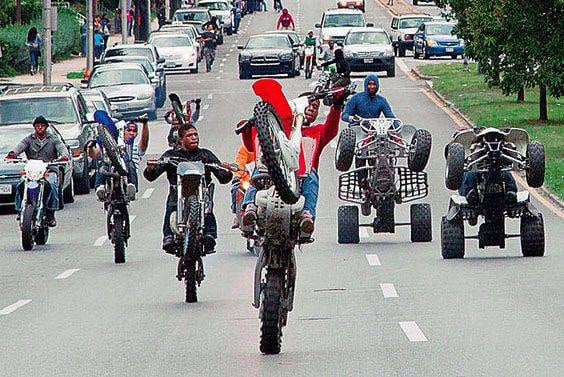 Bike life riders popping wheelies in a street takeover