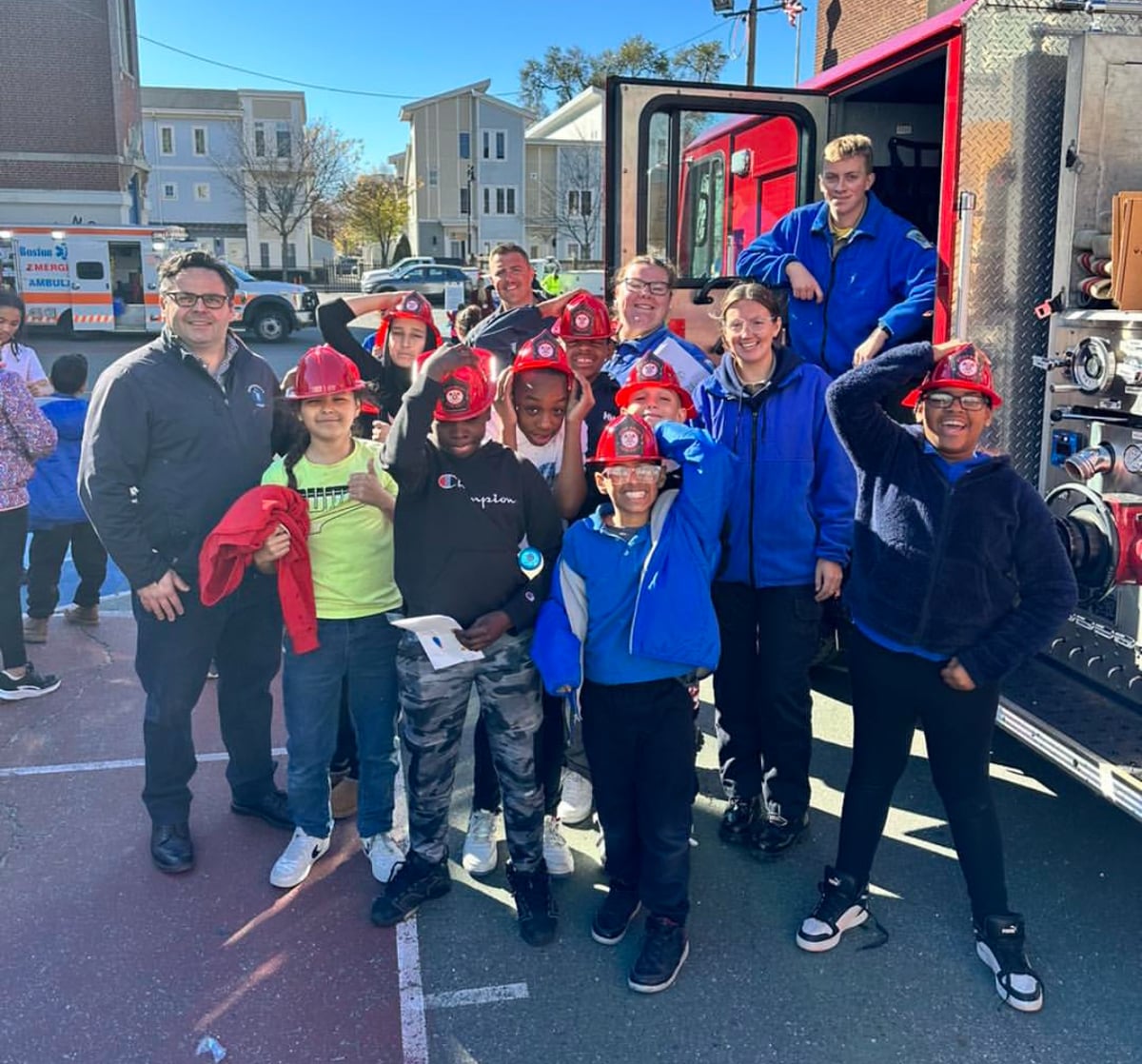 Sen. Nick Collins with students and Boston firefighters at a community event