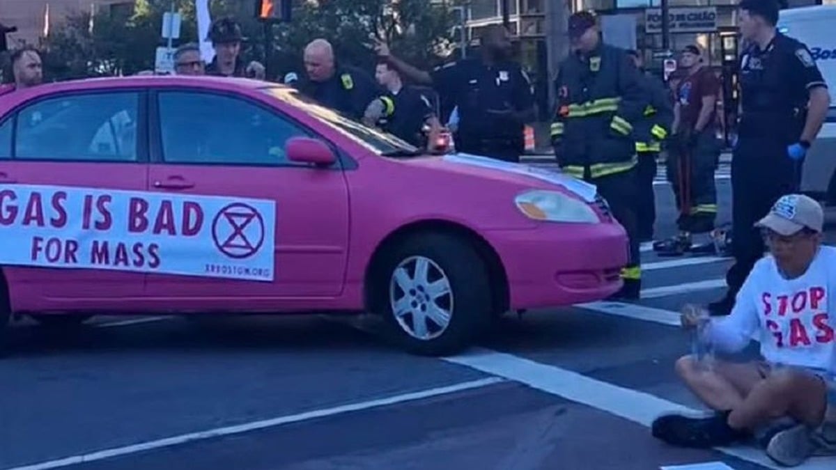 Climate activists weld themselves to a pink car, block Back Bay Boston traffic — Boston Police haul out the power saws to cut them off the road