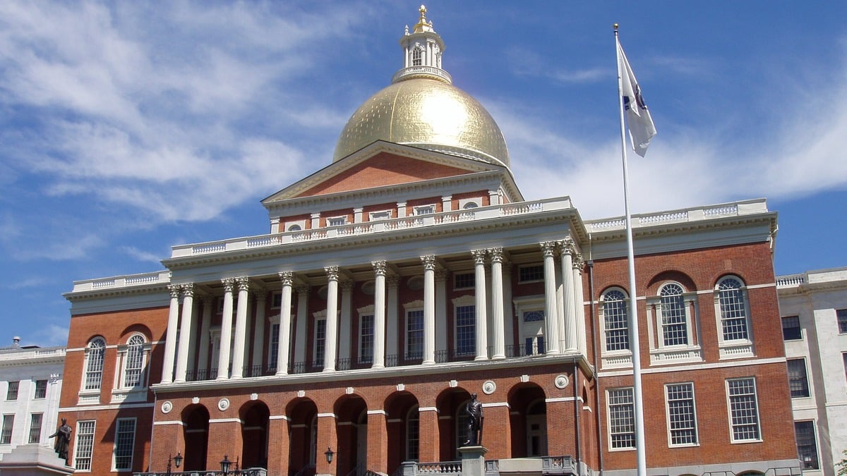 The Massachusetts State House in Boston, golden dome with state flag.