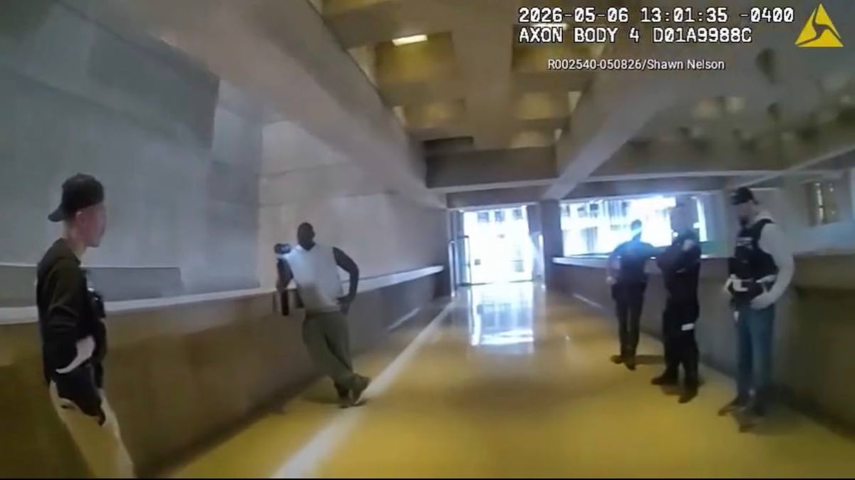 Multiple Boston Police officers around Shawn Nelson inside City Hall on May 6, 2026.