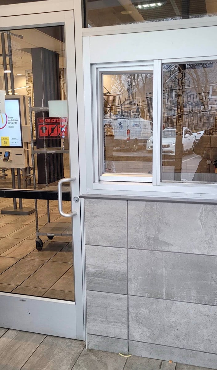 Inside the Roxbury McDonald's vestibule, where customers order through a window built into the wall.