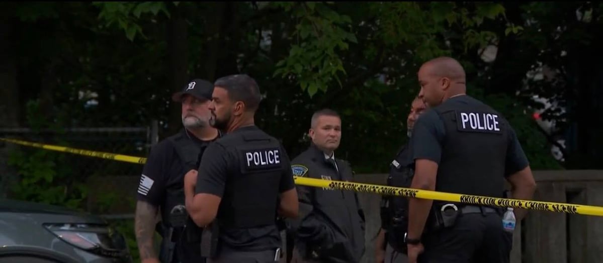 Brockton police officers behind yellow crime scene tape at Main and Park streets.