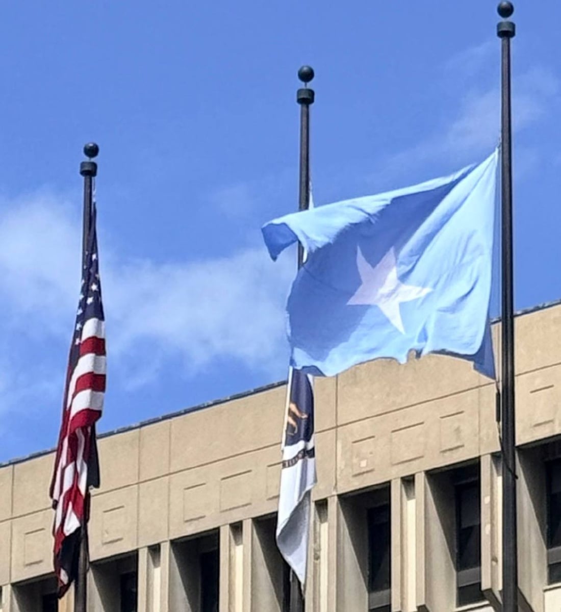 The Somali flag flies over Boston City Hall on Friday alongside the American flag and the Boston city flag.