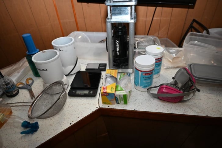 Kilo press and drug trafficking materials recovered from Mendes residence