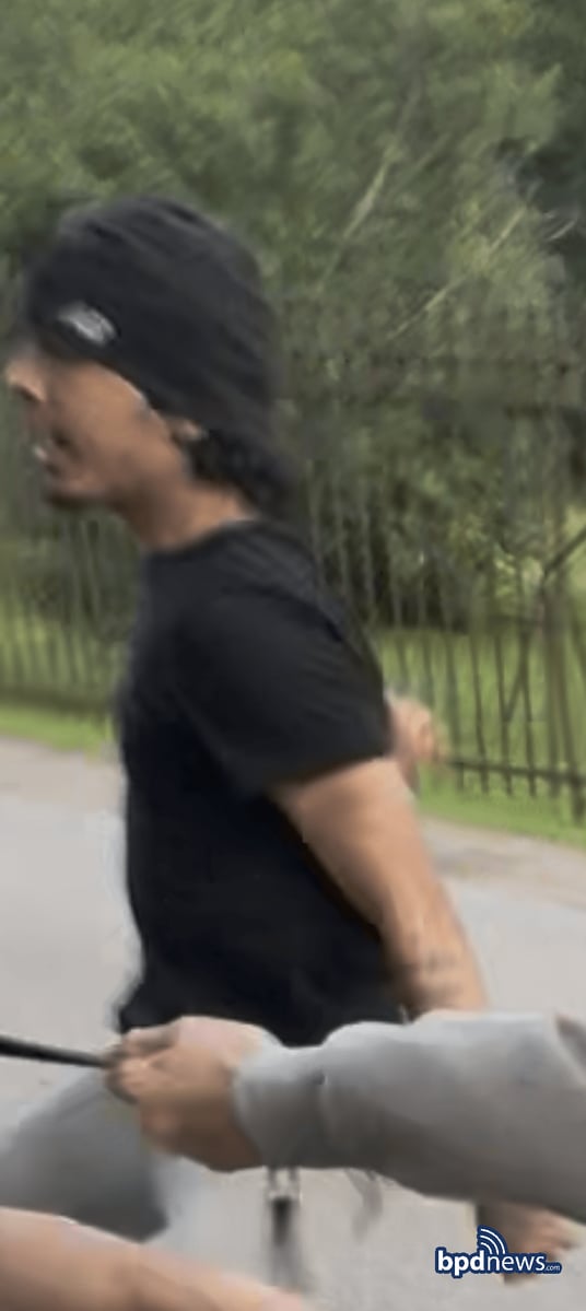 Suspect in a black t-shirt and beanie, with visible tattoos. Photo: Boston Police Department.